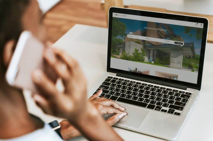Annonce immobilière consultée sur un ordinateur avec des photos de qualité et des documents de vente
